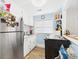 Compact kitchen with white cabinets, stainless steel refrigerator, and an abundance of natural light at 401 17Th Ave. S, North Myrtle Beach, SC 29582
