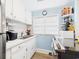 Well-lit kitchen with white cabinets, modern appliances, and ample counter space for meal preparation at 401 17Th Ave. S, North Myrtle Beach, SC 29582