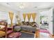 The living room has a floral couch, leather chair, hardwood floors and great natural light at 401 17Th Ave. S, North Myrtle Beach, SC 29582