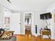 Inviting living room with hardwood floors and a view into the adjacent bedroom with a TV on the wall at 401 17Th Ave. S, North Myrtle Beach, SC 29582