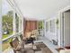 Screened porch features seating and a table, providing a relaxing outdoor space with views of the surrounding greenery at 401 17Th Ave. S, North Myrtle Beach, SC 29582