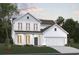 Charming two-story home with white siding, a covered porch, attached garage, and a beautifully landscaped yard at 4023 Braid Ct., Myrtle Beach, SC 29588