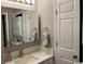 Well-lit bathroom includes a modern vanity, mirror, and convenient stacked washer and dryer at 415 Ocean Creek Dr. # 2117, Myrtle Beach, SC 29572