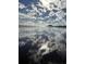 Scenic beach view reflecting the sky and clouds on the wet sand, with the ocean in the background at 415 Ocean Creek Dr. # 2117, Myrtle Beach, SC 29572