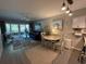 Living area with a dining space and access to the outdoor balcony at 415 Ocean Creek Dr. # 2117, Myrtle Beach, SC 29572