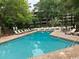 Large community pool surrounded by lounge chairs, inviting relaxation under the sun at 415 Ocean Creek Dr. # 2117, Myrtle Beach, SC 29572