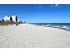 Expansive sandy beach with clear blue ocean waters and distant buildings at 4303 South Ocean Blvd. # 303, North Myrtle Beach, SC 29582