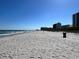 Long sandy beach with crashing waves and coastal buildings on the horizon at 4303 South Ocean Blvd. # 303, North Myrtle Beach, SC 29582