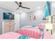 Cozy bedroom featuring two twin beds, a ceiling fan, and a mounted television at 4303 South Ocean Blvd. # 303, North Myrtle Beach, SC 29582