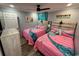 Cozy bedroom featuring two twin beds, a ceiling fan, and a mounted television at 4303 South Ocean Blvd. # 303, North Myrtle Beach, SC 29582
