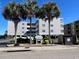 Exterior view of WindSong building featuring beachy landscapes and palm trees at 4303 South Ocean Blvd. # 303, North Myrtle Beach, SC 29582