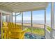 Enjoy ocean views from this relaxing screened porch with yellow Adirondack chairs at 4303 South Ocean Blvd. # 303, North Myrtle Beach, SC 29582