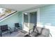 Cozy covered balcony offers outdoor seating and sliding door access to the interior at 4307 Beverly Ct., North Myrtle Beach, SC 29582