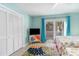 Light-filled bedroom with closet, mounted TV, slider to deck, and bright, colorful decor at 4307 Beverly Ct., North Myrtle Beach, SC 29582