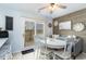 The dining area has a farmhouse-style table and a sliding door to the outdoor space at 4307 Beverly Ct., North Myrtle Beach, SC 29582