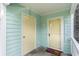 Welcoming entryway featuring a welcome mat and a door with a 'Sandy Feet Welcome' sign at 4307 Beverly Ct., North Myrtle Beach, SC 29582