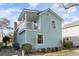 Charming light blue home with a stone chimney and manicured landscaping at 4307 Beverly Ct., North Myrtle Beach, SC 29582