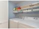 Laundry room featuring a full-sized washer and dryer with storage shelves at 4307 Beverly Ct., North Myrtle Beach, SC 29582