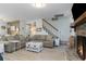 Bright living room features a fireplace, coastal decor, and a staircase to the upper level at 4307 Beverly Ct., North Myrtle Beach, SC 29582