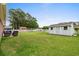 Large, lush backyard with a wooden shed and a white picket fence, perfect for outdoor activities at 4639 Mandi Ave., Little River, SC 29566