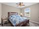 Warm bedroom with a wooden bed frame, cozy bedding, and a window overlooking the yard at 4639 Mandi Ave., Little River, SC 29566