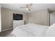 Neutral bedroom showcasing a ceiling fan, television on a dresser, and a comfortable bed at 4639 Mandi Ave., Little River, SC 29566