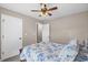 Inviting bedroom with blue floral bedding, a ceiling fan, and natural light at 4639 Mandi Ave., Little River, SC 29566