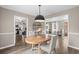 Dining room with a table set for two, opening to the kitchen and a sunlit living area at 4639 Mandi Ave., Little River, SC 29566