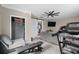Spacious home gym featuring a treadmill and weight bench, leading into an open-concept living area at 4639 Mandi Ave., Little River, SC 29566