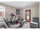 Home gym featuring a treadmill, weights, and an exercise bench, near a door at 4639 Mandi Ave., Little River, SC 29566