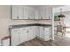 Corner kitchen with ample cabinet space, open shelving, and vinyl floors at 4639 Mandi Ave., Little River, SC 29566