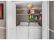 Organized laundry room with washer, dryer, and shelving for storage solutions at 4639 Mandi Ave., Little River, SC 29566
