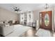 Bright and airy living room with hardwood floors, three windows and a stylish fireplace with white curtains at 4639 Mandi Ave., Little River, SC 29566