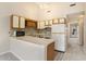 Cozy kitchen with white appliances, light wood cabinetry, and a peninsula overlooking the living space at 510 Fairwood Lakes Dr. # 18N, Myrtle Beach, SC 29577