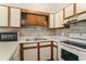 Efficient kitchen showcasing white cabinets, a microwave, range, and a dual stainless steel sink at 510 Fairwood Lakes Dr. # 18N, Myrtle Beach, SC 29577
