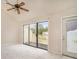 Open living room featuring vaulted ceilings, ceiling fan, sliding glass doors to deck, and neutral carpet at 510 Fairwood Lakes Dr. # 18N, Myrtle Beach, SC 29577