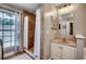 Modern bathroom featuring a tiled shower, a vanity with a sink, and a window for natural light at 5113 Pee Dee Ln., Murrells Inlet, SC 29576