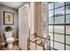 Neutral toned bathroom featuring toilet, window with decorative window film, and laundry basket at 5113 Pee Dee Ln., Murrells Inlet, SC 29576