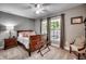 Cozy bedroom with two windows, a ceiling fan, a wood bed frame, and neutral decor at 5113 Pee Dee Ln., Murrells Inlet, SC 29576