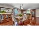 Elegant dining area with hardwood floors, stylish chandelier, and views into the kitchen at 5113 Pee Dee Ln., Murrells Inlet, SC 29576