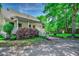 A side view of the home, showcasing its porch, plantings, and lovely yard at 5113 Pee Dee Ln., Murrells Inlet, SC 29576