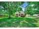 Charming traditional home with a inviting front porch and well-manicured lawn surrounded by mature trees at 5113 Pee Dee Ln., Murrells Inlet, SC 29576