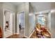 Hallway with view into bathroom and a bedroom with hardwood floors, rocking chair, and reading lamp at 5113 Pee Dee Ln., Murrells Inlet, SC 29576