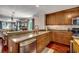 Well-lit kitchen featuring wood cabinets, stainless steel appliances, and an open layout to the living area at 5113 Pee Dee Ln., Murrells Inlet, SC 29576