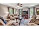 Comfortable living room with large windows, plush seating, ceiling fan and hardwood floors at 5113 Pee Dee Ln., Murrells Inlet, SC 29576