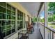 Exterior porch featuring decorative plants, rocking chairs, and a wicker side table at 5113 Pee Dee Ln., Murrells Inlet, SC 29576
