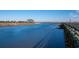 A serene water view with clear skies, a pier, and distant shorelines at 5113 Pee Dee Ln., Murrells Inlet, SC 29576
