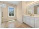Bright bathroom with a single vanity and walk-in shower with a window offering views of the outdoors at 5460 Huntington Marsh Rd., Murrells Inlet, SC 29576