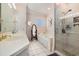 Bathroom features a soaking tub, glass-enclosed shower, and white vanity with ample counter space at 5460 Huntington Marsh Rd., Murrells Inlet, SC 29576