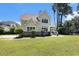 Beautiful exterior view of a home with a rounded porch and lush landscaping at 5460 Huntington Marsh Rd., Murrells Inlet, SC 29576